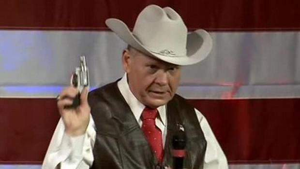 Beloved State Senator Wendall “Grandpa” Batshitowski proposes requiring all children to pack heat in the classroom, for their protection. Here he is demonstrating a prototype of the new “Fun Size” Revolver (for ages 5 and under).